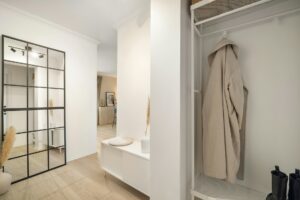 walk-in closet with a coat rack and mirror