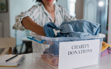 Packing clothes in donation box for charity organization