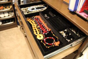 shallow velvet-lined closet drawer with jewelry inside