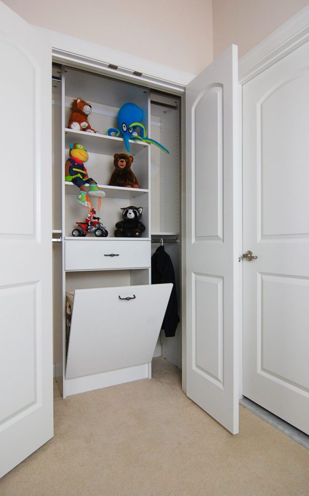 child's closet with organizers and storage drawers
