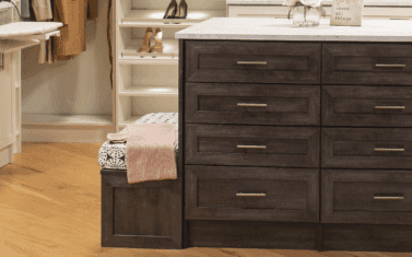 walk-in closet with center island and custom bench seating with storage