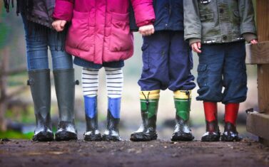 school children in mud boots going to school