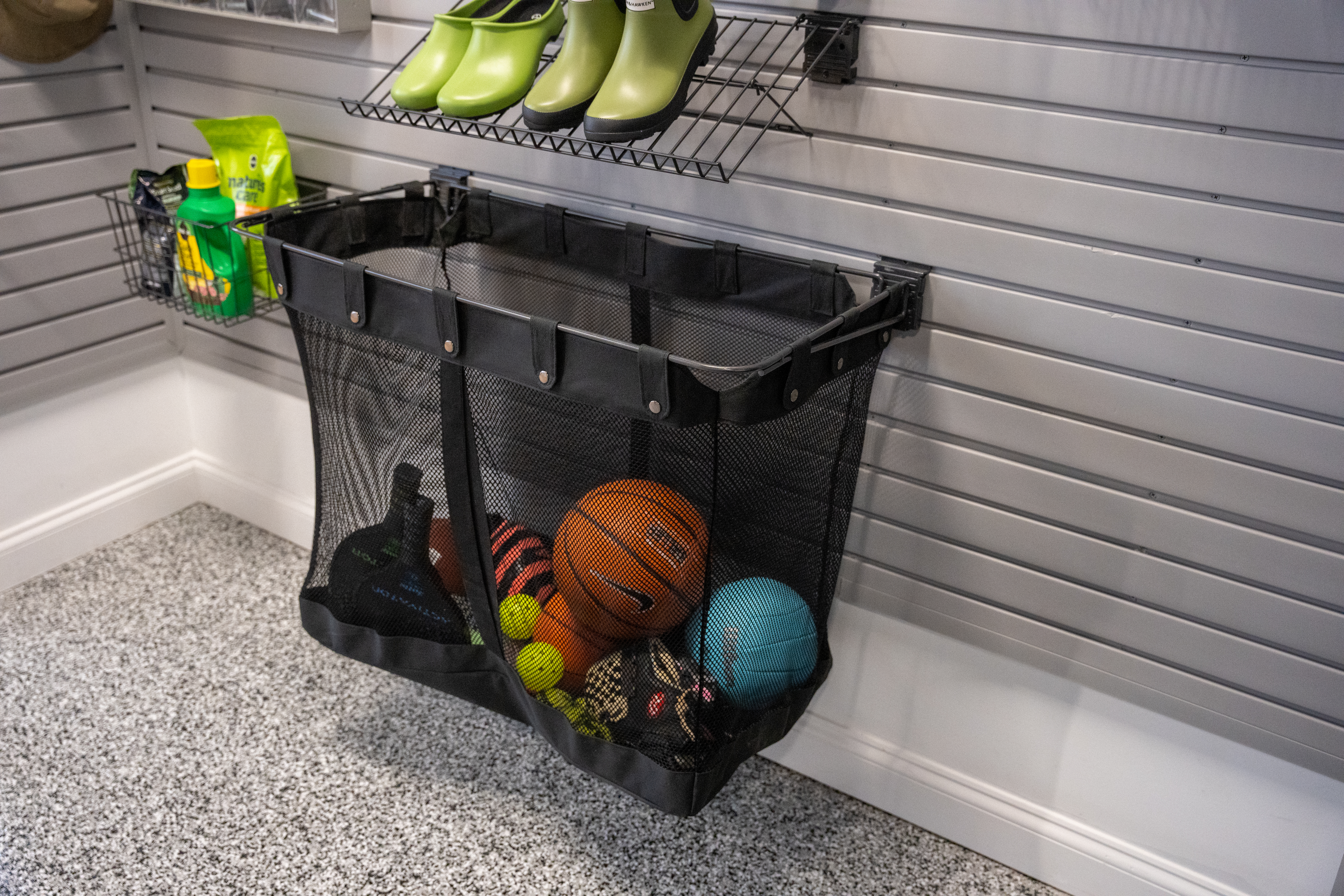 garage wall pegboard with basket containing sports balls