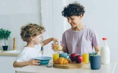 Mother and son eating breakfast in a kitchen