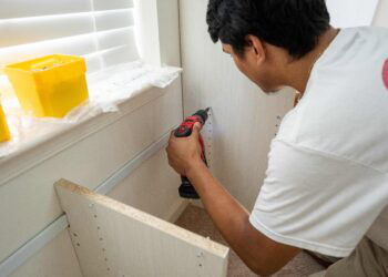 Installing a custom closet into the wall with a drill